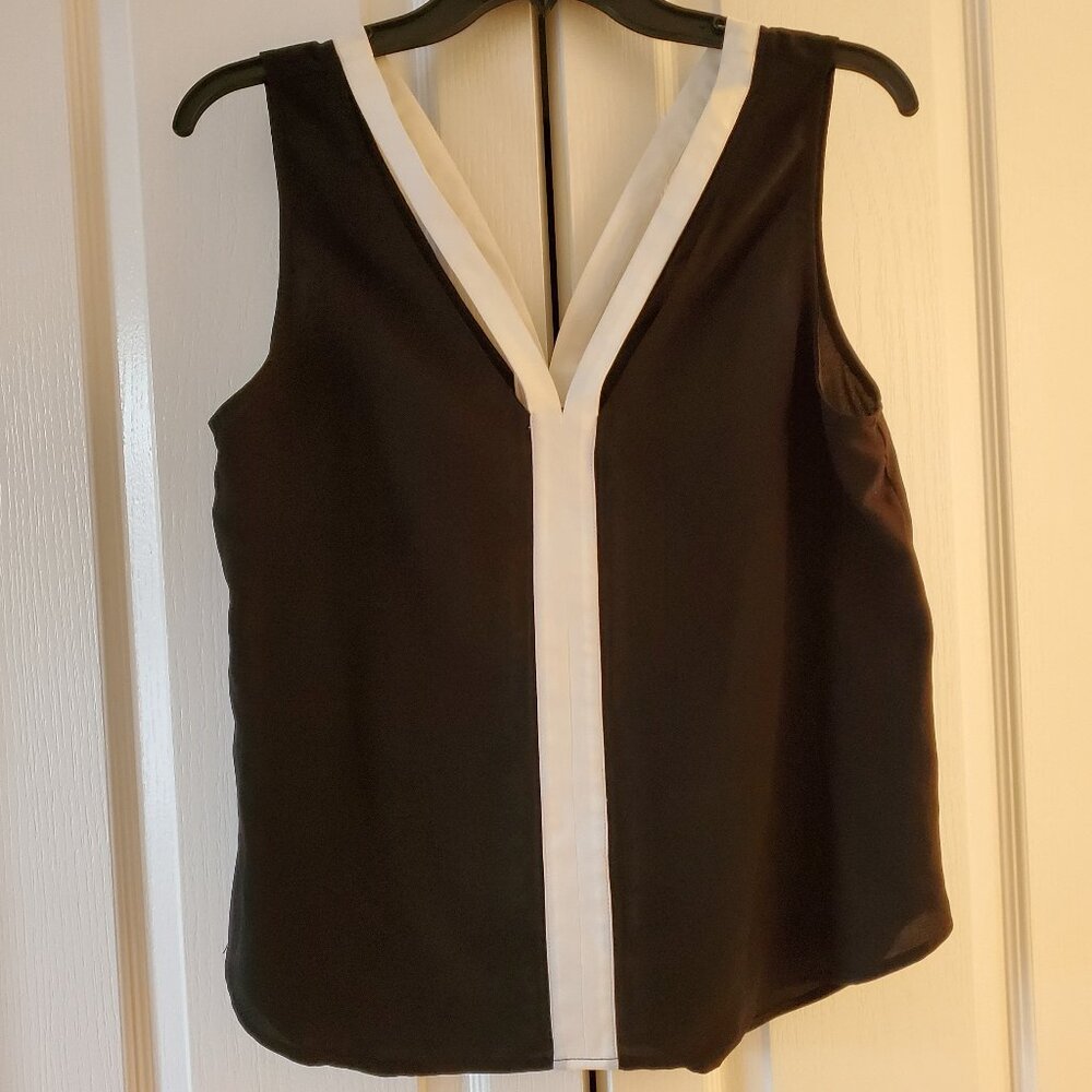 Trouve black camisole top with white trim along; size medium